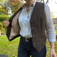 Load image into Gallery viewer, Lady wears Pika Vest over a long sleeved shirt, opened to reveal contrasting lining fabric
