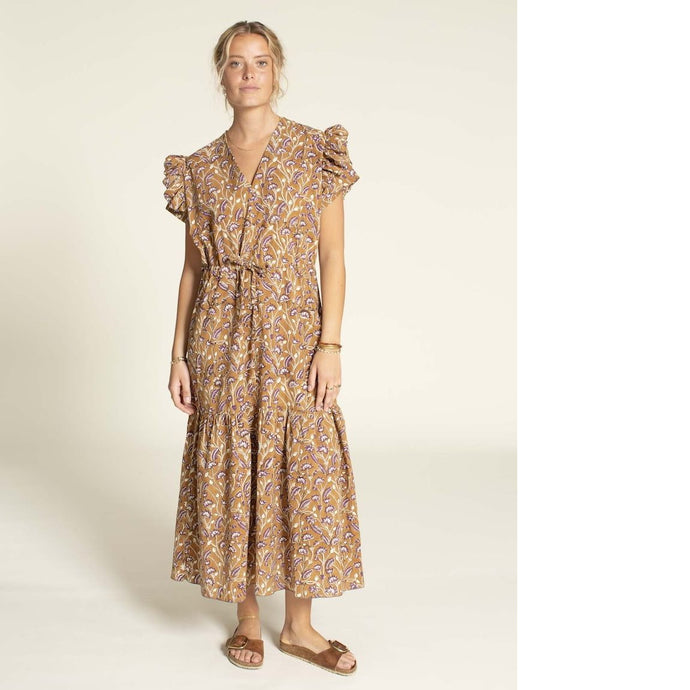 Model wears an Abby Dress View B: a V-neck dress with ruffles at armhole, tiered maxi skirt, with waist tie