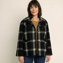 Load image into Gallery viewer, Model wears a short checkered coat with two welt pockets, and three buttons
