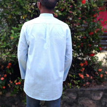 Load image into Gallery viewer, Back view of model wearing a button stand collared shirt, with box bleat at yoke
