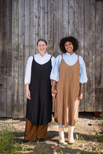 Load image into Gallery viewer, Two ladies holding hands wearing loose pleated strap dresses over 3/4 length puffy sleeved blouses
