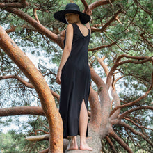 Load image into Gallery viewer, Lady wears a sleeveless dress and centre back slit from hem, amidst a tree
