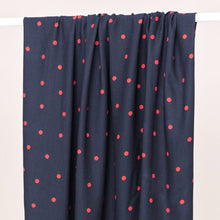 Load image into Gallery viewer, Dot print EcoVero Viscose Crepe fabric hangs over a rail
