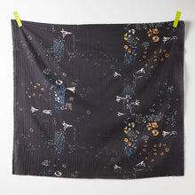 Load image into Gallery viewer, Square piece of Organic Cotton Double Gauze fabric hangs on a wall by two pieces of tape at the top two corners, displays a floral print
