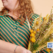 Load image into Gallery viewer, Close up of lady holding bunch of flowers, wearing a collared, top button-up blouse made with Grasslands Viscose
