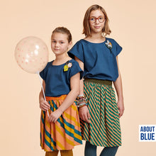 Load image into Gallery viewer, Two young people wear diagonal stripe pattern skirts standing next to one another
