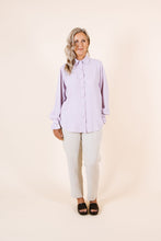 Load image into Gallery viewer, Lady wears a classic buttoned-up shirt, but with gathered frill detail at cuff
