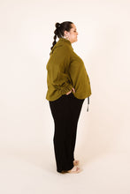 Load image into Gallery viewer, Side view of lady wearing an Ashling shirt with gathered and frill cuffs on long sleeves

