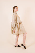 Load image into Gallery viewer, Side view of lady wearing Ashling long sleeved dress, with frilled waistline, frill cuffs, knee-length skirt

