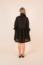 Load image into Gallery viewer, Back view of lady wearing Ashling long sleeved dress, with frill collar, frill cuffs, gathered waistline, knee-length skirt
