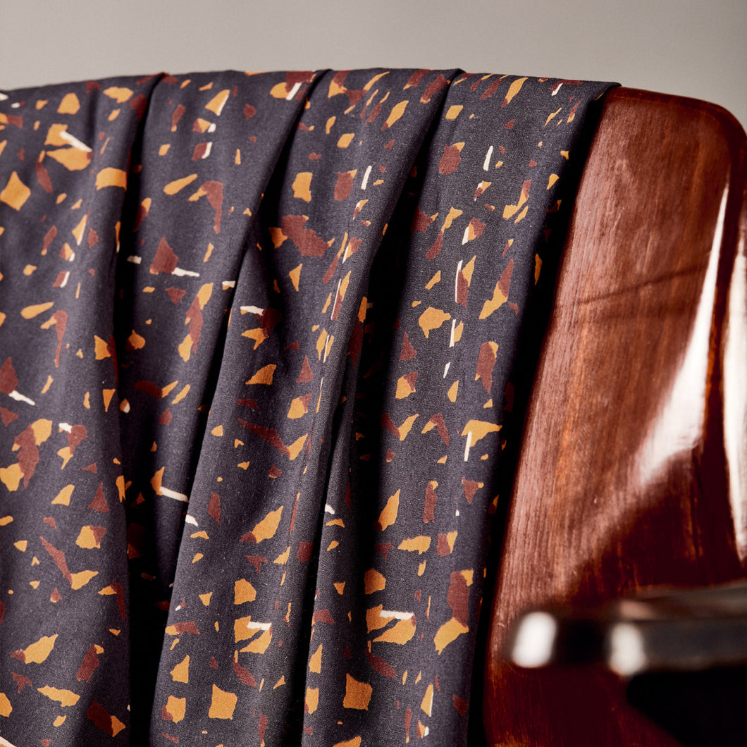 Candy Rock Tender Toffee Modal fabric drapes over the back of a chair