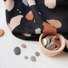 Load image into Gallery viewer, Viscose Fabric drapes next to a pot of smooth pebbles
