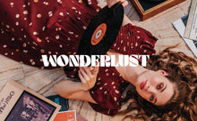 Load image into Gallery viewer, Lady lays on rug holding a vinyl record, wears a pleated dress made from the Fizzy Rust EcoVero Viscose Twill fabric

