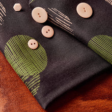 Load image into Gallery viewer, Close up of Jane Maple EcoVero Viscose fabric with buttons lain on top
