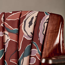 Load image into Gallery viewer, EcoVero Viscose fabric in soft pleat folds on the back of a chair
