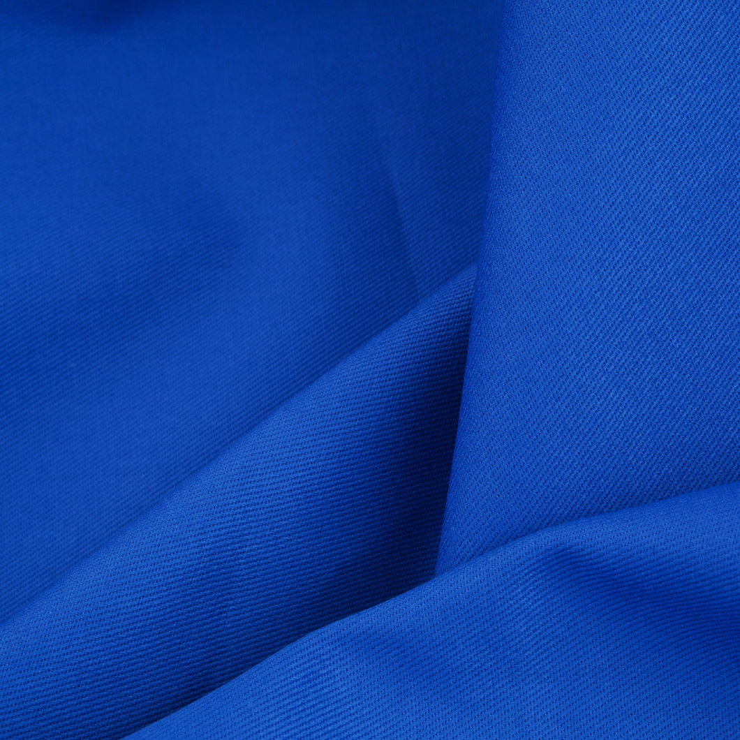 Close up of royal blue cotton drill fabric folding drapery.