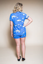 Load image into Gallery viewer, Back view of lady standing wearing a short sleeve shirt and shorts pyjama set in patterned fabric
