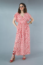 Load image into Gallery viewer, Lady with hand in pockets wears a full length kaftan dress
