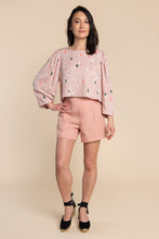 Load image into Gallery viewer, Lady stands wearing a boxy top with puff sleeve detail
