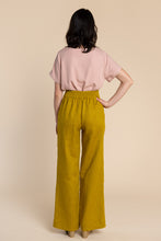 Load image into Gallery viewer, Back view of lady wearing Pietra Trousers with elasticated waist back
