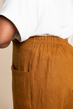 Load image into Gallery viewer, Side view close up of Pietra Trousers shows slanted front pocket inseam, and the elasticated waist back
