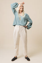 Load image into Gallery viewer, Lady wears tapered Mitchell Trousers, with hand on hip
