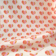 Load image into Gallery viewer, Organic Cotton Fabric hangs, shows pattern of loveheart shaped &#39;hugs&#39; words
