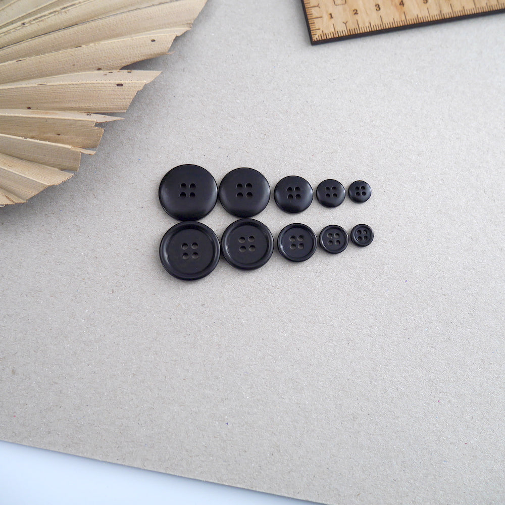 Five different sized Corozo buttons lined up