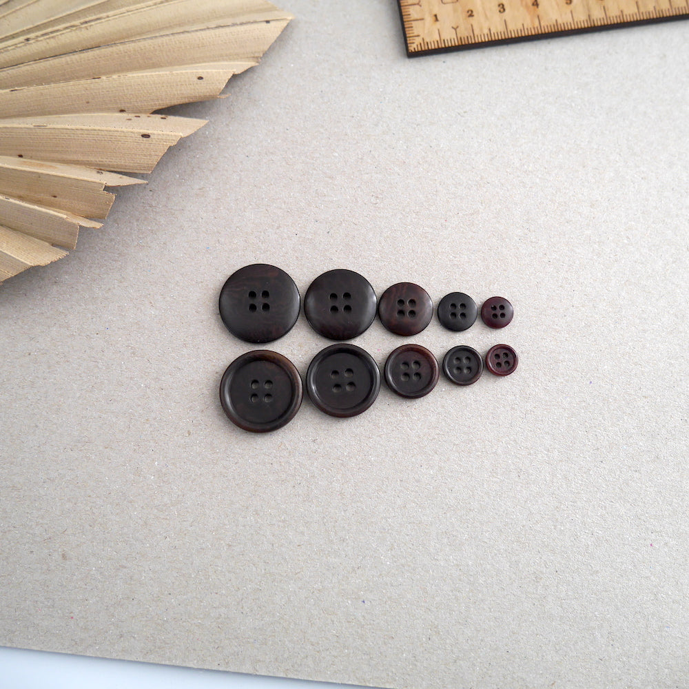 Five different sized Corozo buttons lined up