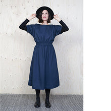 Load image into Gallery viewer, Lady wearing dress with elasticated cuff and waist detail in a denim like fabric, layered over a black jersey top and black tights.
