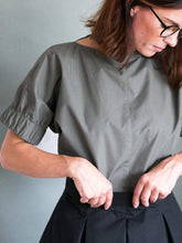 Load image into Gallery viewer, Close up view of lady wearing a khaki green top with elasticated cuff.
