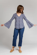 Load image into Gallery viewer, Lady wears V-neck Dove Blouse showing off flared sleeves
