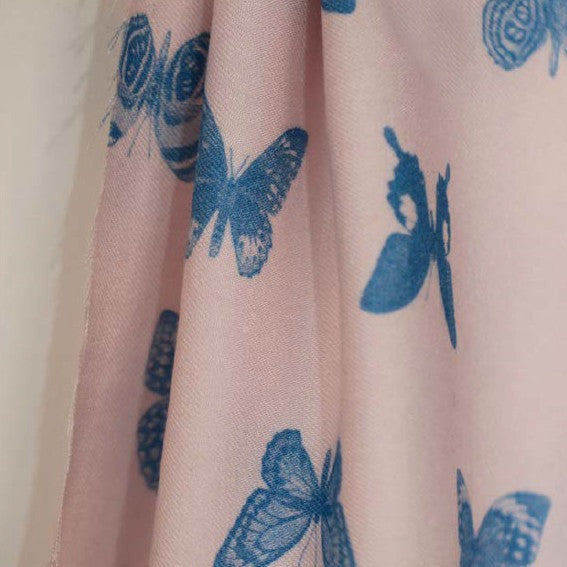 Edmond EcoVero Viscose Twill fabric hangs to show soft folds, with a butterfly print