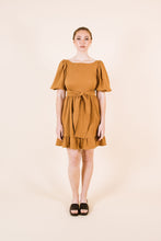 Load image into Gallery viewer, Front view of Estella dress with waist ties, and knee-length skirt with frill hem
