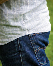 Load image into Gallery viewer, Close up of hemline at side angle, showing a curve.
