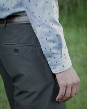 Load image into Gallery viewer, Close up of cuff of long sleeve shirt, fastened with button.

