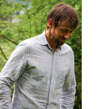 Load image into Gallery viewer, Man wears a button-up shirt with slim collar and chest pocket.
