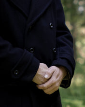 Load image into Gallery viewer, Close up of sleeve cuffs showing sleeve tabs fastened with buttons.
