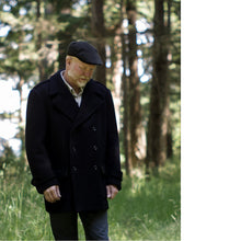 Load image into Gallery viewer, Man wears a black double breasted peacoat. Worn with flatcap.
