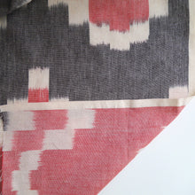 Load image into Gallery viewer, Ikat Cotton Fabric folded back on itself reveals identical weave on reverse
