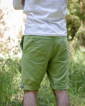 Load image into Gallery viewer, Back view of man wearing Jedediah Pants, showing yoke and two pockets, rolled up hems.
