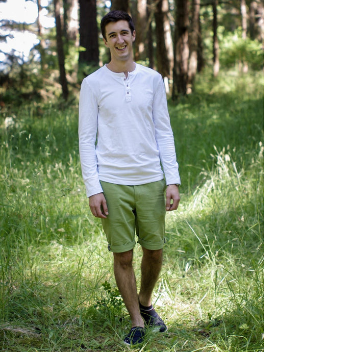 Man wears Jedediah Pants knee-length shorts in lime green fabric.
