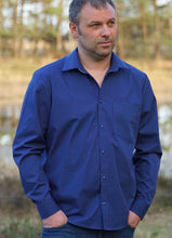 Load image into Gallery viewer, Man wears Jensen shirt with pointed collar and one chest pocket in bold blue fabric.
