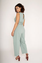 Load image into Gallery viewer, Back view of lady wearing mint jumpsuit showing opening at the top.
