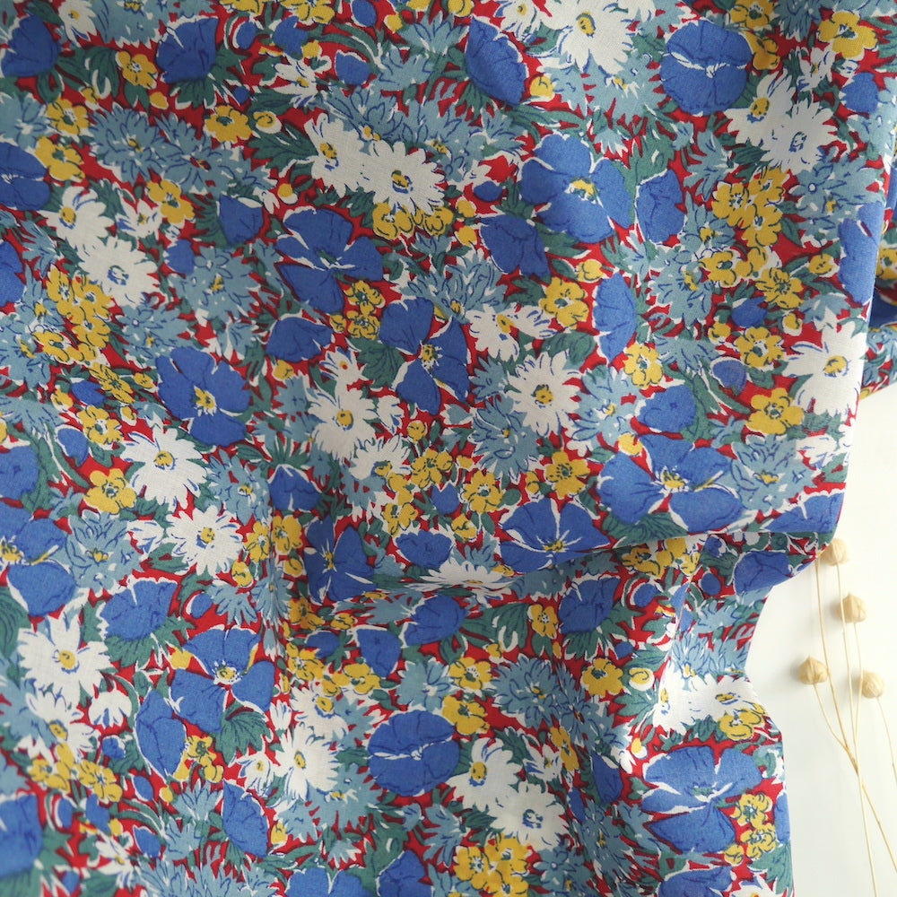 Floral print fabric slightly crumpled displayed against a plain surface