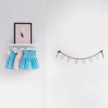 Load image into Gallery viewer, Three hanging babywear dresses made with Lightening Lily Crystal Blue Cotton Fabric, and other fabrics from the Soft Cactus collection. Displayed with bunting made from fabric from the Soft Cactus collection.
