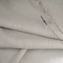 Load image into Gallery viewer, Linen fabric in gentle folds with dried flower stems on top
