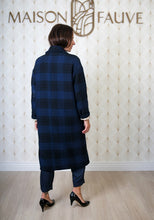 Load image into Gallery viewer, Back view of lady wearing a long Pam Coat with sleeves rolled up to reveal patterned lining fabric
