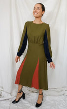 Load image into Gallery viewer, Lady wears Sonia dress made with different coloured panels for a colour blocking effect
