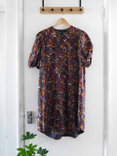 Load image into Gallery viewer, Anthea Dress with puff sleeves, made with Hilma Rust EcoVero fabric displayed on hanger
